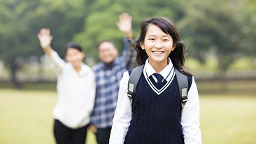 cute young student girl with parent in school