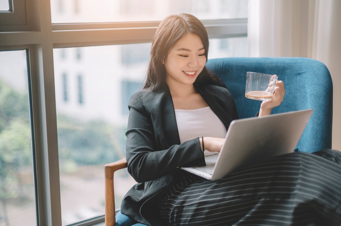 A lady looking at her laptop